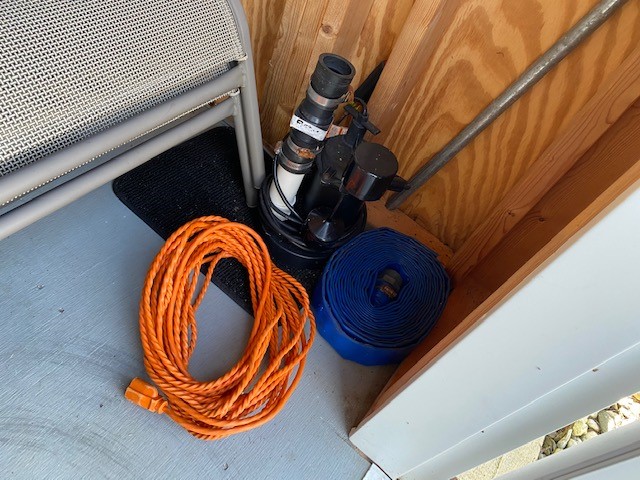 Submersible Pump and Hose in Pool Shed